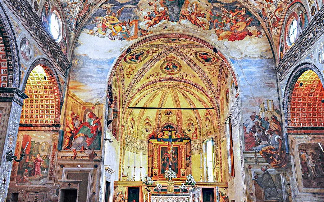 Interior of Santa Maria delle Grazie, Milan, with frescoes and ornate altar.