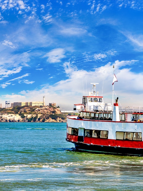 Ferry with tourists approaching Alcatraz Island in San Francisco Bay, California.