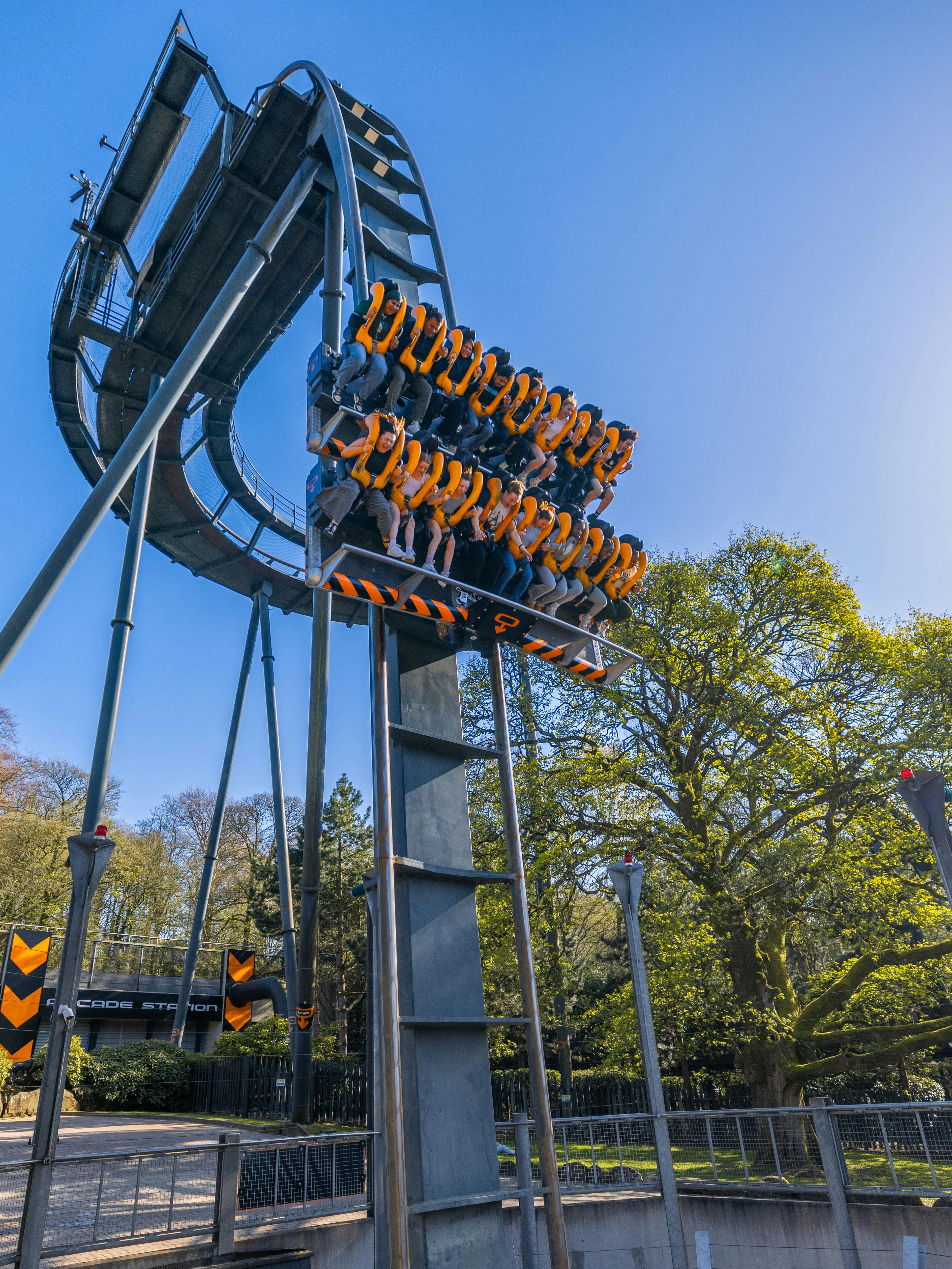 Roller coaster ride at Alton Towers with passengers suspended vertically.