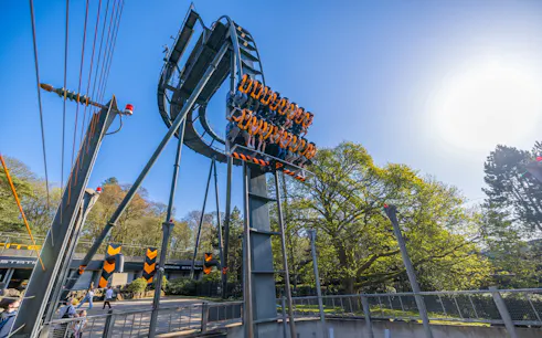 Roller coaster ride at Alton Towers with passengers suspended vertically.