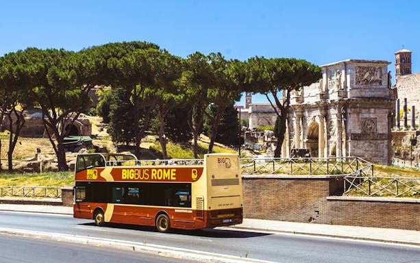 Open-top double-decker bus touring past the Colosseum in Rome, Italy, part of Big Bus Tours Rome.