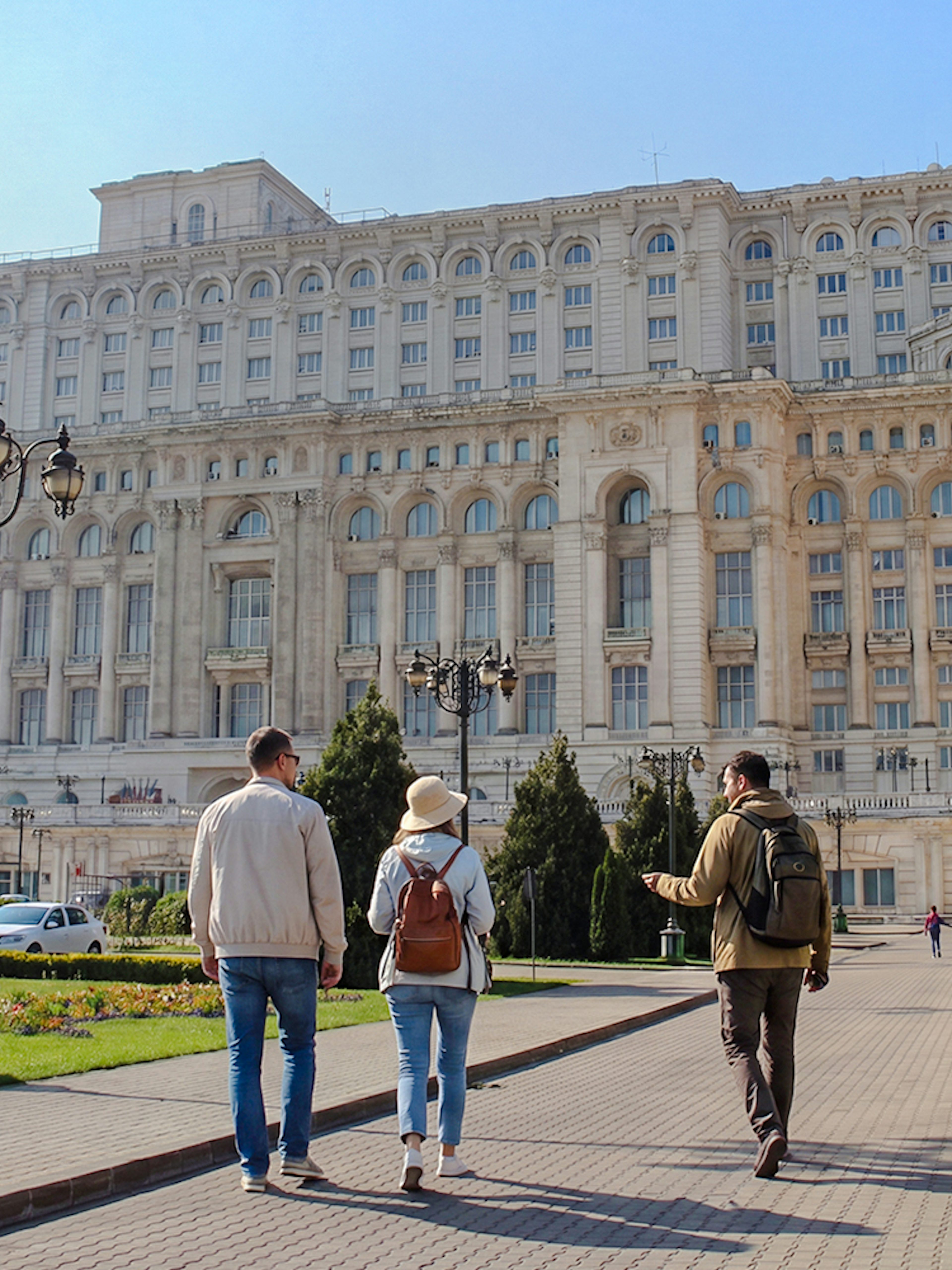 Visitors walking towards the Palace of the Parliament in Bucharest, Romania.