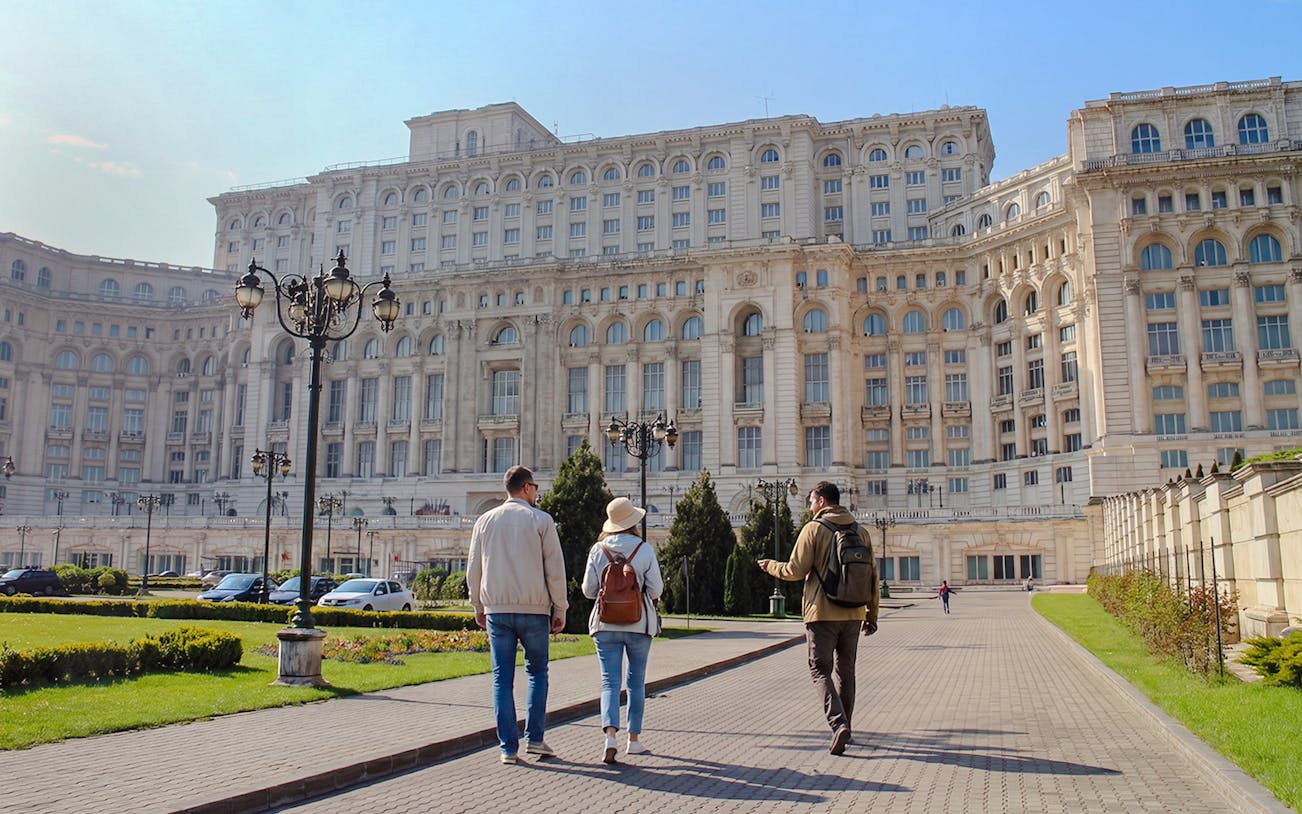 Visitors walking towards the Palace of the Parliament in Bucharest, Romania.