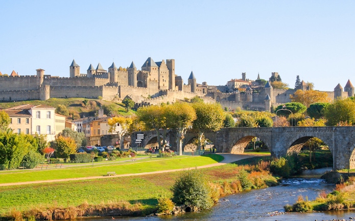 Carcassonne town view with medieval castle and stone bridge in the background.