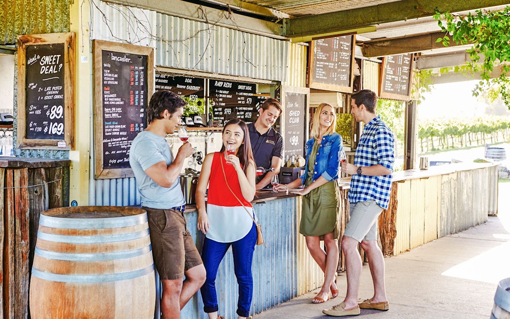 Group enjoying wine tasting at a vineyard bar in Swan Valley.