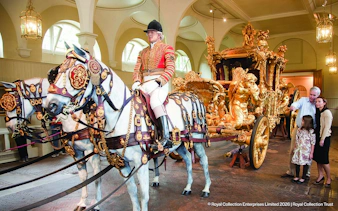 Royal Mews carriage with ornate gold details and horses, part of Changing of the Guard tour.