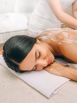 Woman receiving a relaxing massage at a spa.
