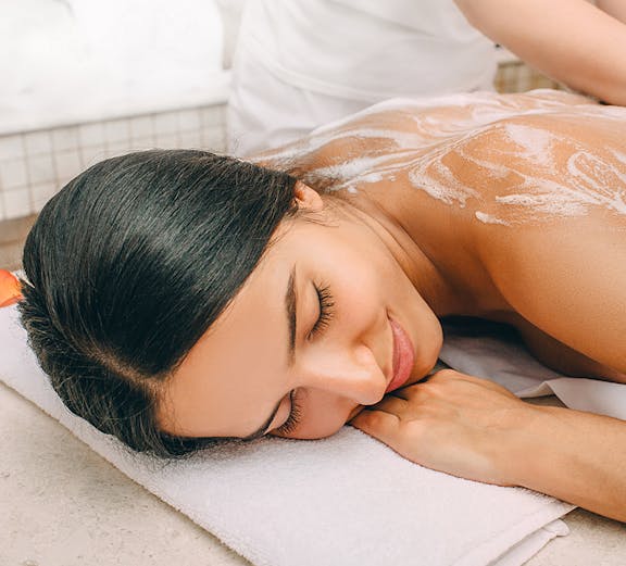 Woman receiving a relaxing massage at a spa.