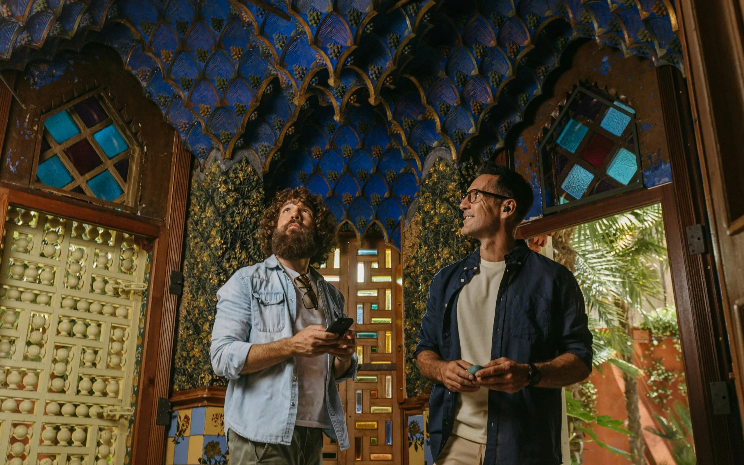 Tourists admiring intricate ceiling design at Casa Vicens in Barcelona.