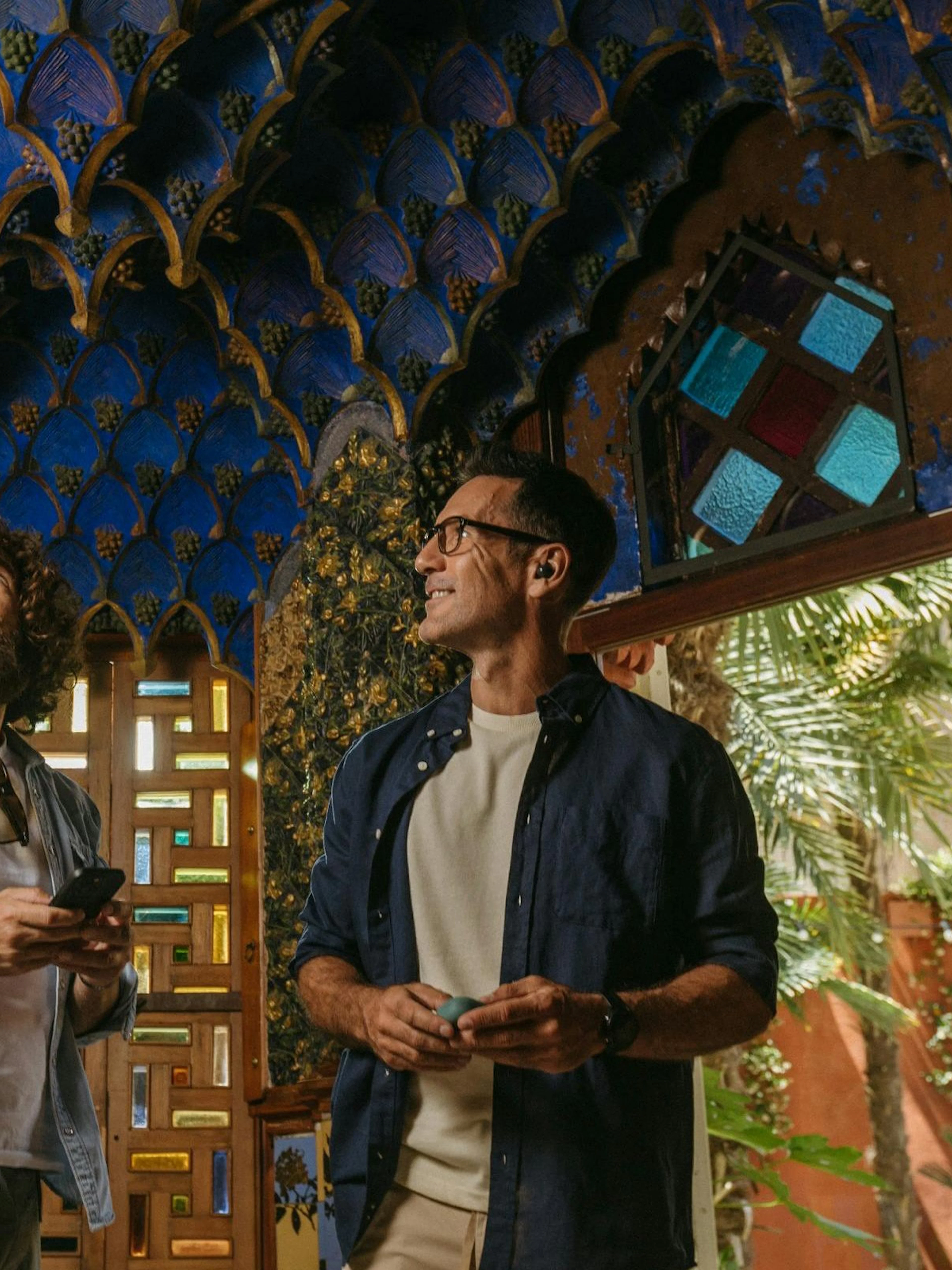 Tourists admiring intricate ceiling design at Casa Vicens in Barcelona.