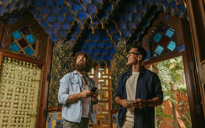 Tourists admiring intricate ceiling design at Casa Vicens in Barcelona.