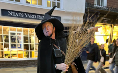Guide in witch costume leading York Old Town walking tour.