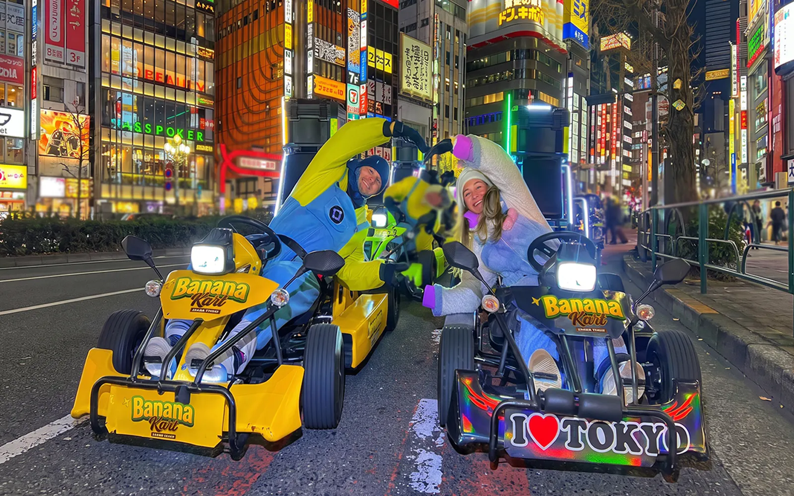 Go-kart riders in costumes on Banana Kart tour, Shinjuku to Shibuya, Tokyo at night.
