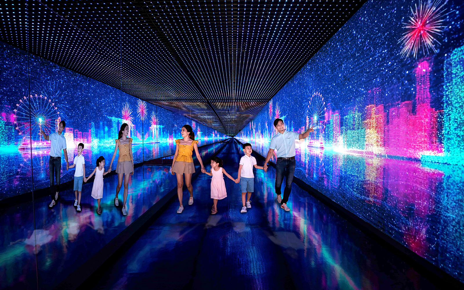 Families walking through the Time Capsule at Singapore Flyer with digital cityscape and fireworks.