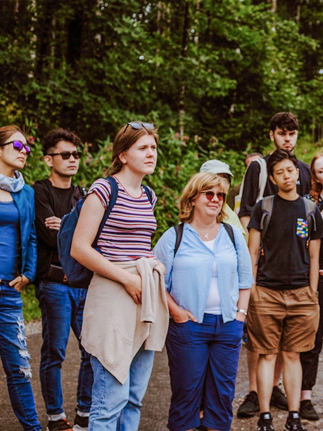 Tour group listening to a guide near Neuschwanstein Castle, Germany.
