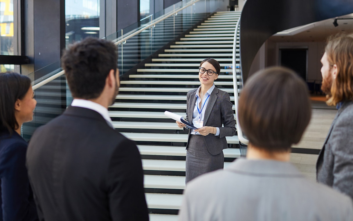 Tour guide leading a group at the Shard, London.