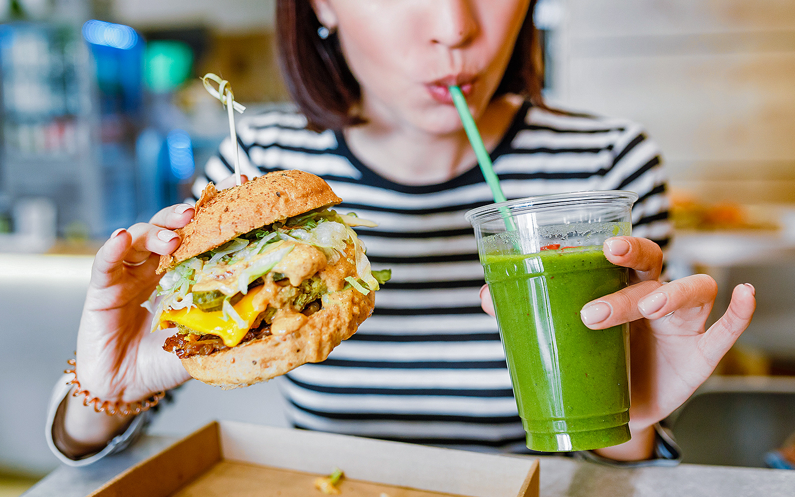 Woman having a burger and smoothie