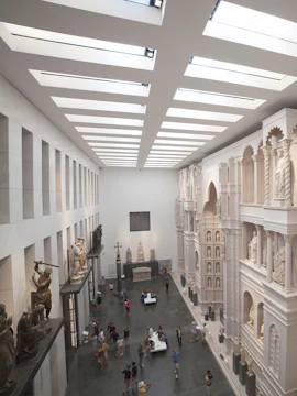 Visitors exploring sculptures and architectural displays inside Museo dell'Opera del Duomo, Florence.