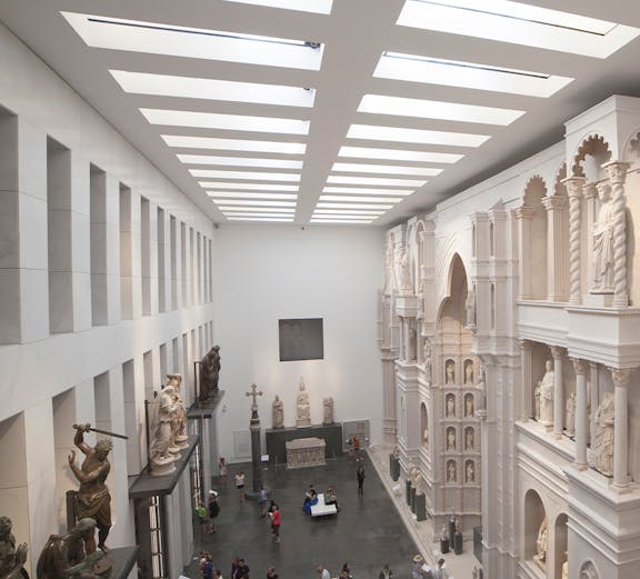 Visitors exploring sculptures and architectural displays inside Museo dell'Opera del Duomo, Florence.