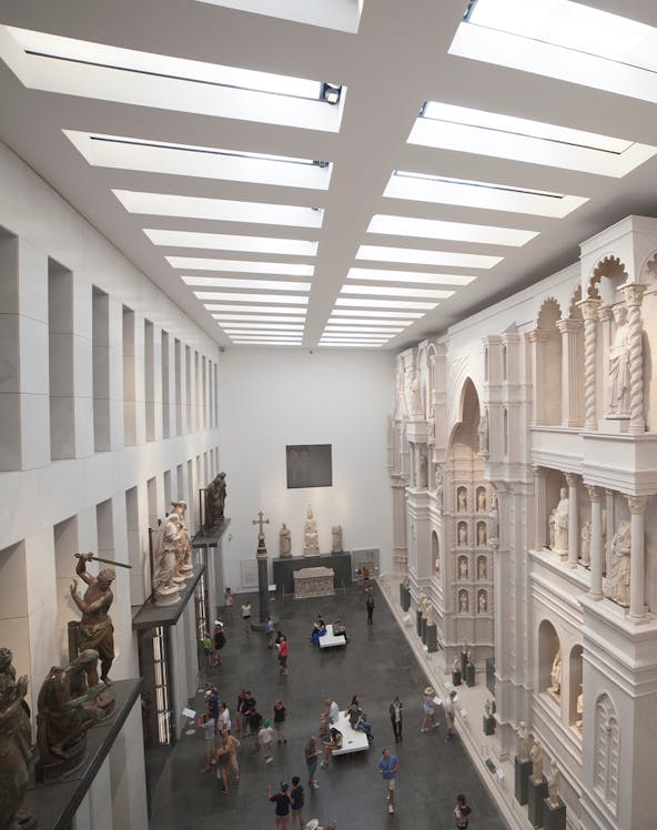 Visitors exploring sculptures and architectural displays inside Museo dell'Opera del Duomo, Florence.