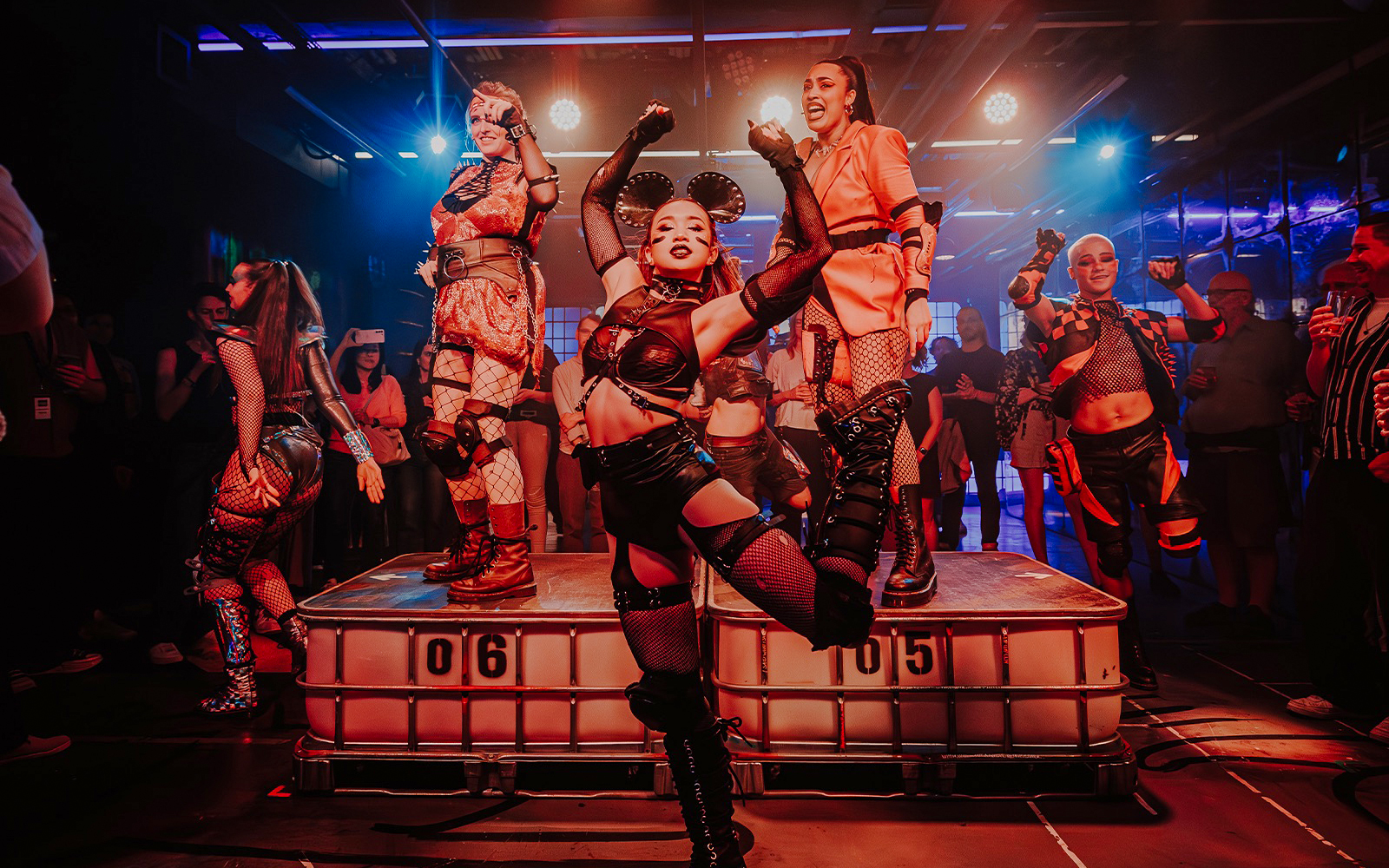 Performers dancing energetically at Oscar at the Crown show.