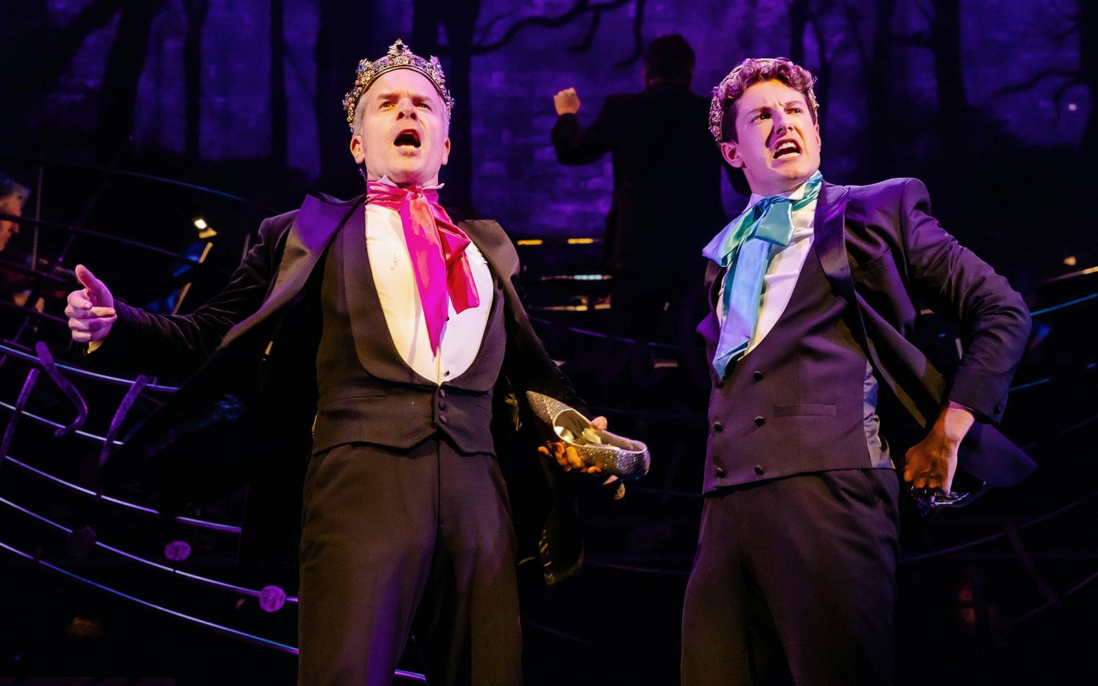 Two actors in formal attire perform on stage in Stephen Sondheim's Old Friends.