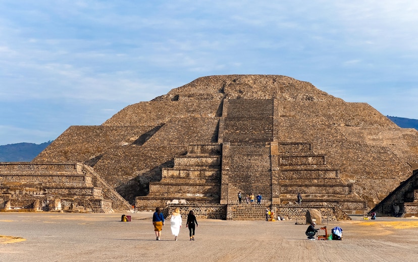 Pyramid of the Moon in Teotihuacan, Mexico, with visitors exploring the ancient site.