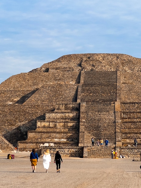 Pyramid of the Moon in Teotihuacan, Mexico, with visitors exploring the ancient site.