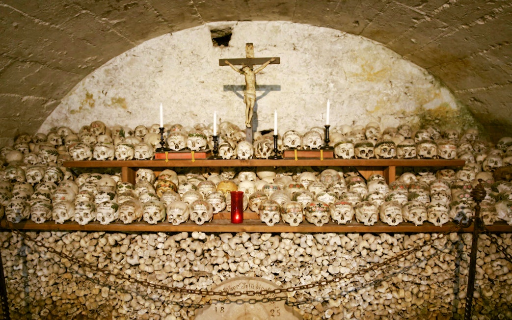 Painted skulls and bones in Hallstatt's Beinhaus, Austria.