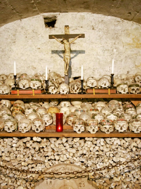 Painted skulls and bones in Hallstatt's Beinhaus, Austria.