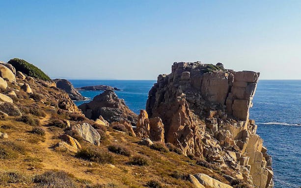 Trek path through rocky terrain in Manago Stone Garden by the sea.