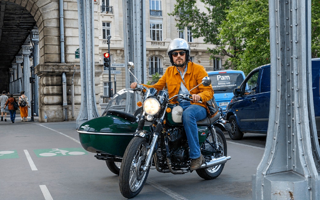 Sidecar motorcycle tour under Paris bridge.