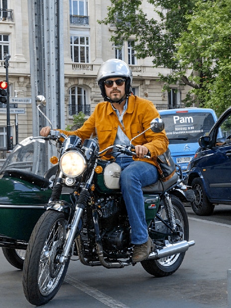 Sidecar motorcycle tour under Paris bridge.