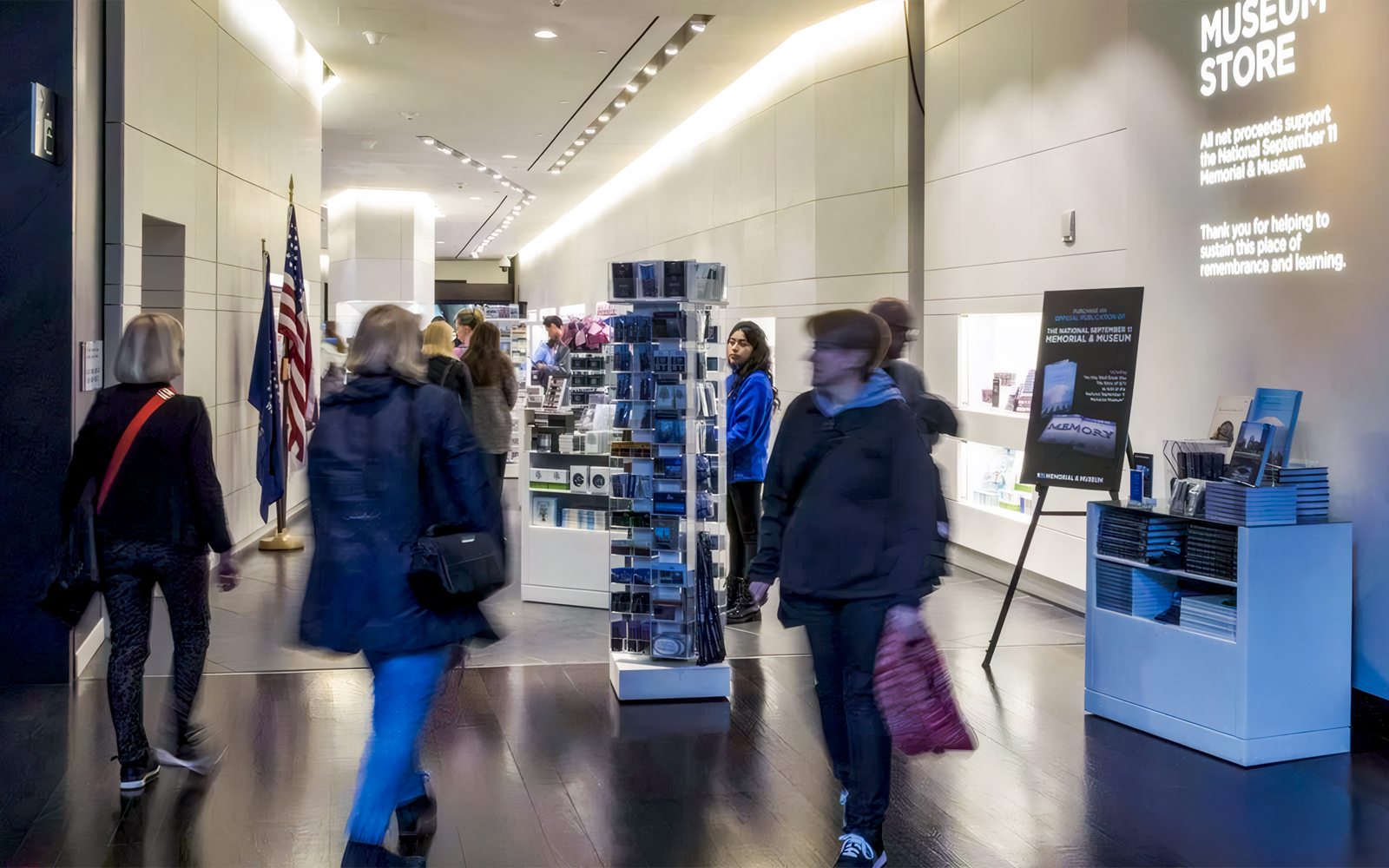 9/11 Museum shop interior with visitors browsing exhibits and merchandise in New York City.