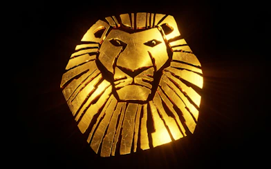 Golden lion head emblem for a stage musical.