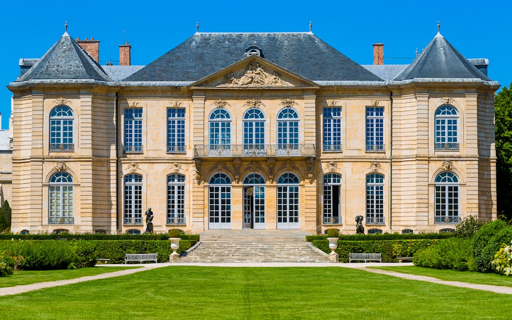 Rodin Museum facade with sculptures in Paris garden.