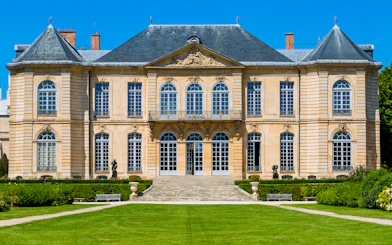 Rodin Museum facade with sculptures in Paris garden.