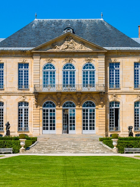 Rodin Museum facade with sculptures in Paris garden.