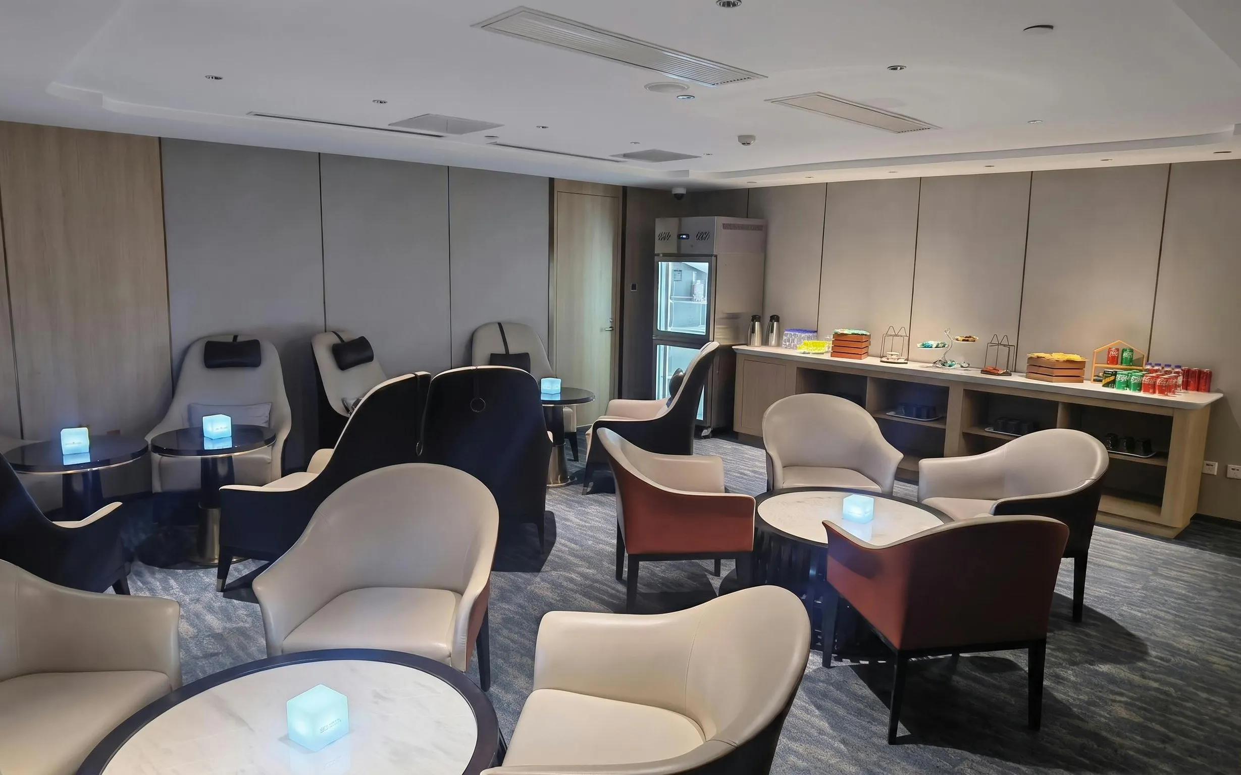 Seating area with refreshments at CHUM Guest 79 Lounge, Daxing International Airport.