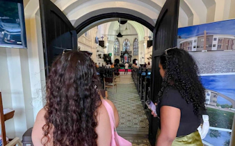 Visitors entering a historic church in Dar es Salaam during a day trip from Zanzibar.
