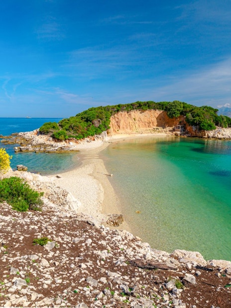 Ksamil Archipelago's Twin Islands with clear turquoise waters and rocky shoreline.