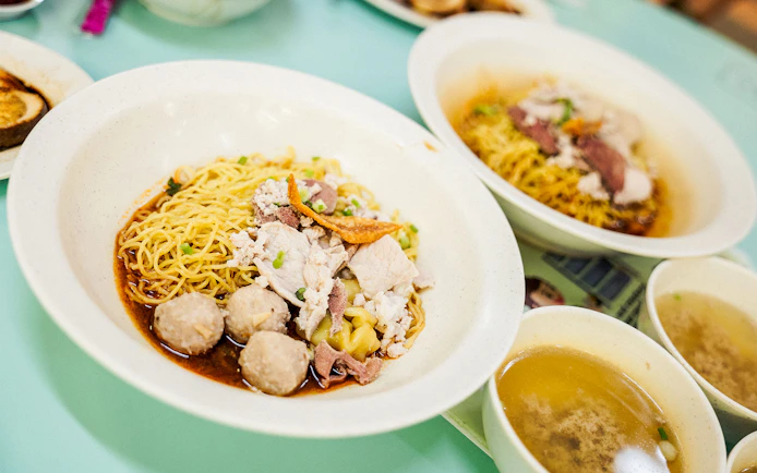 Noodle dish with meatballs and broth on a Guided Michelin and Local Hawker Food Tour.