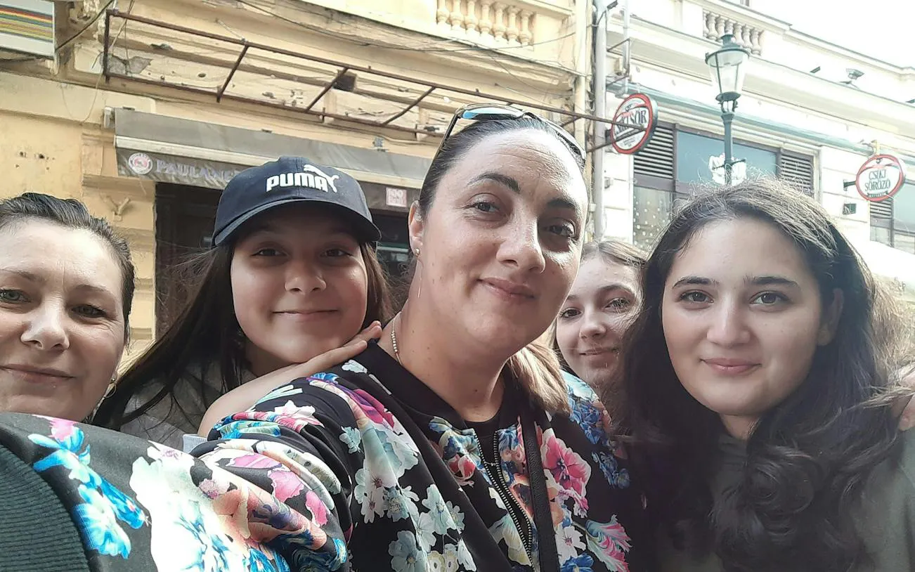 Group of people smiling on a street in Bucharest during a haunted city exploration game.