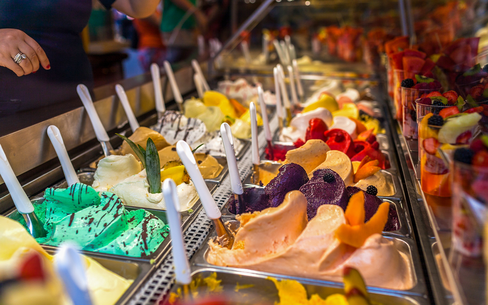 Gelato selection in Florence shop with various flavors and toppings.