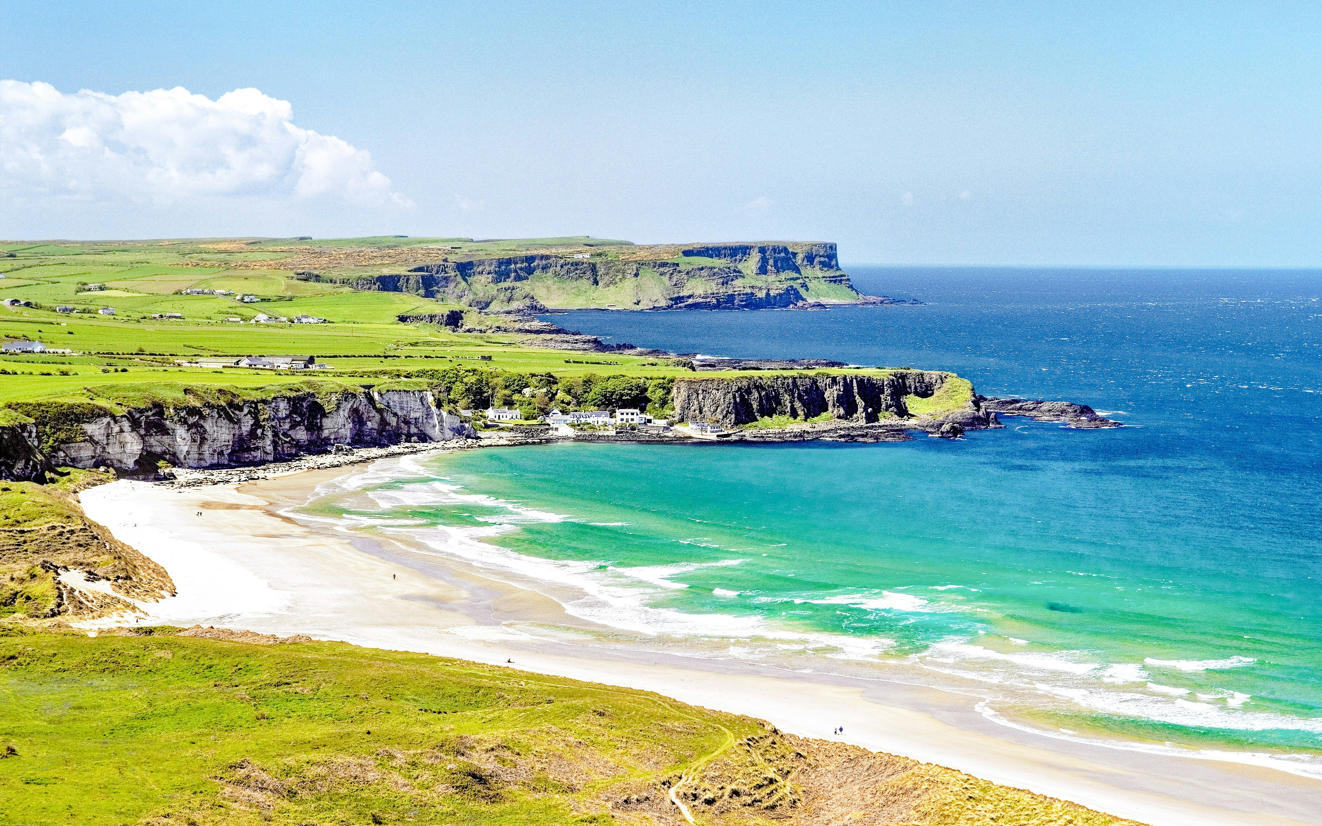 White Park Bay coastline with cliffs and sandy beach in Northern Ireland.