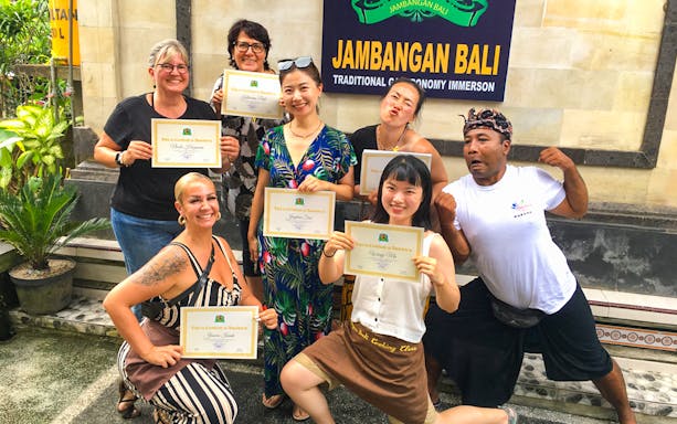 Participants holding certificates at Jambangan Bali Cooking Class in Ubud.