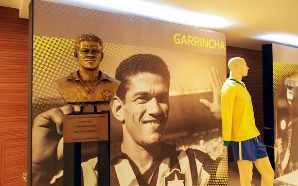 Bust of a football player and mannequin in Maracanã Stadium museum players wall.