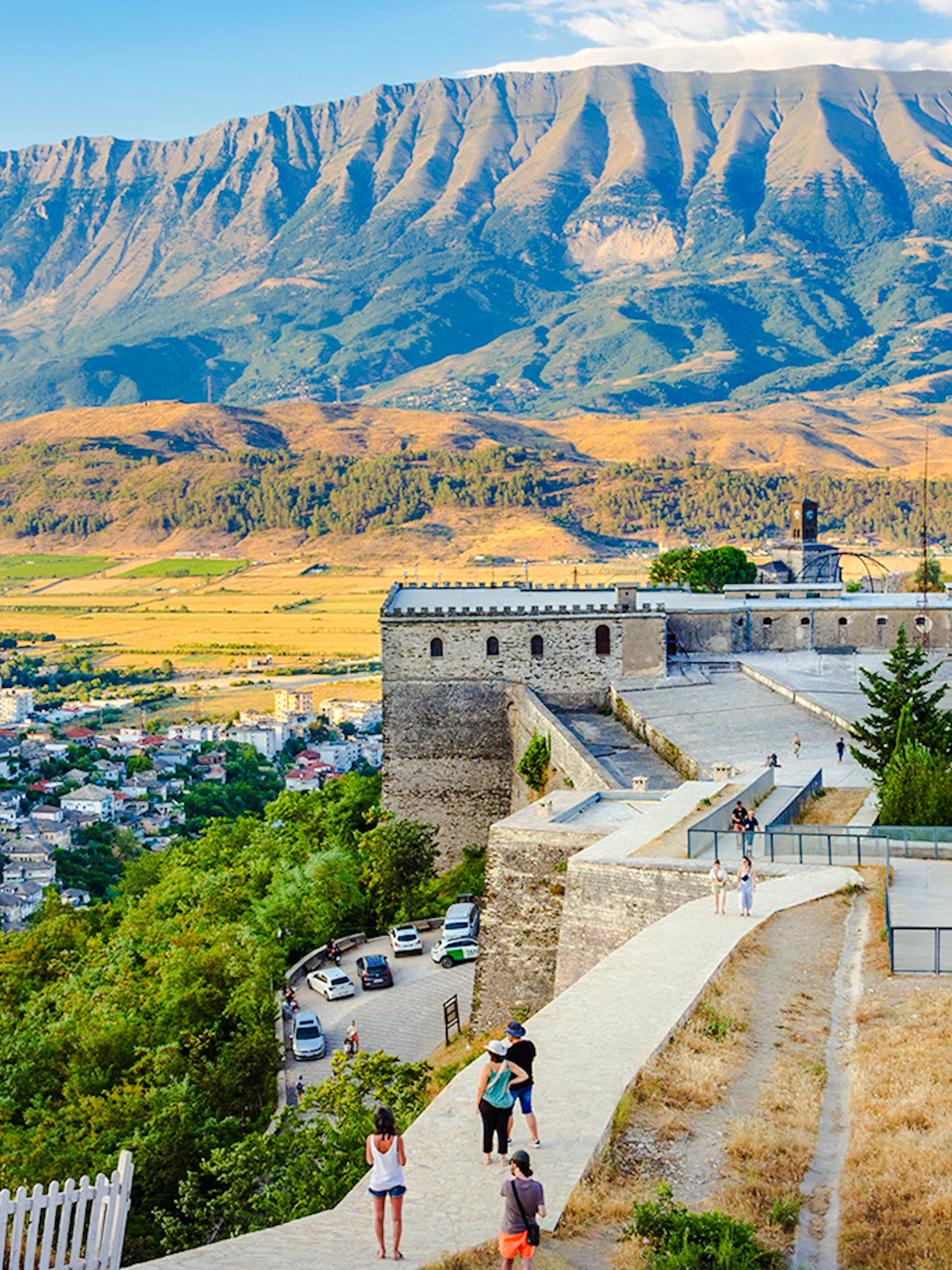Gjirokaster fortress overlooking the city with mountains in the background.