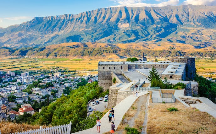 Gjirokaster fortress overlooking the city with mountains in the background.