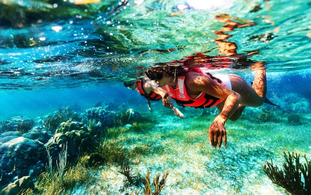 Visitors snorkeling in the Marine National Park, Puerto Morelos, exploring the Great Maya Reef.